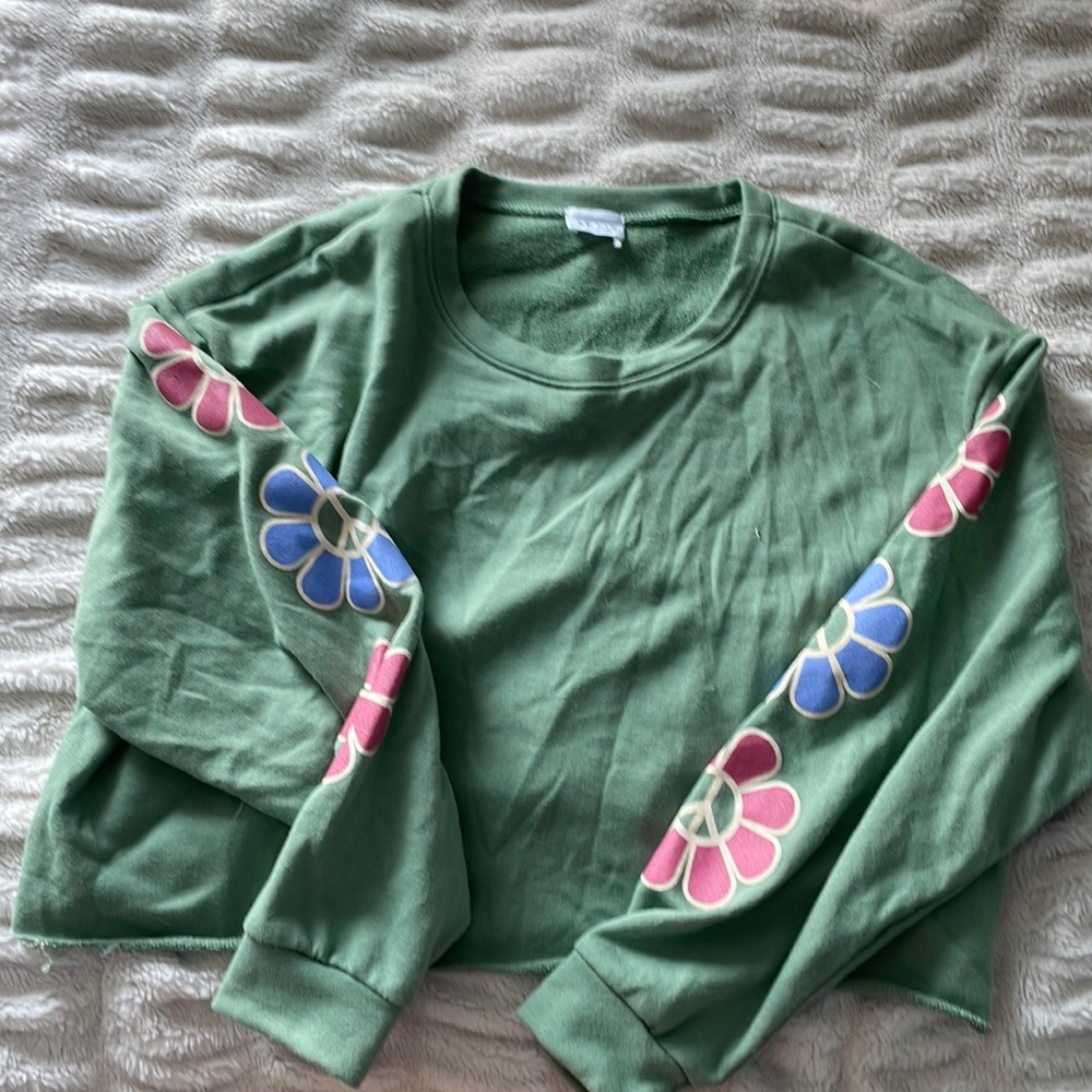 Size M green sweatshirt with flower design on arms. From vanilla sky